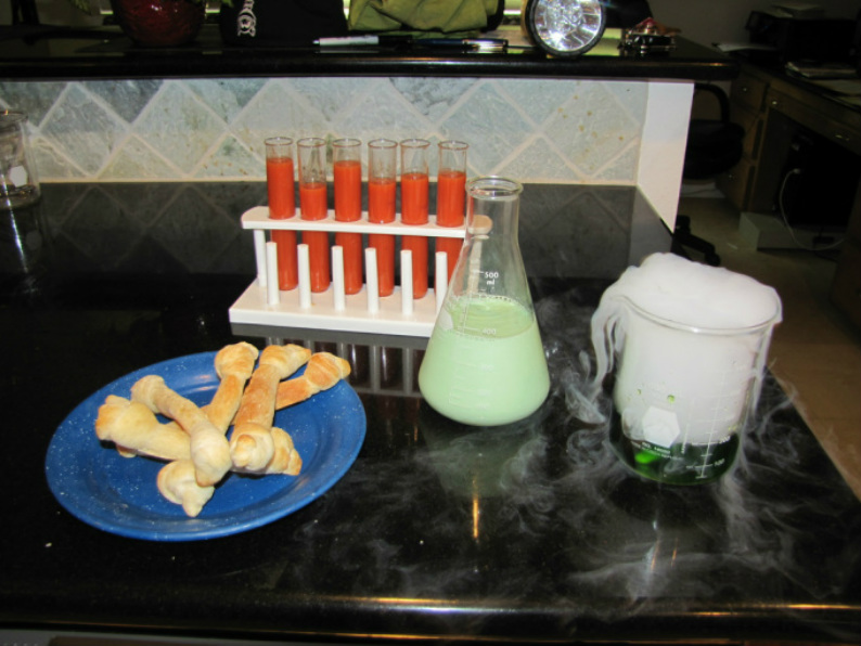 Halloween lunch, blood soup in test tubes, bread stick bones, molded milk in beaker