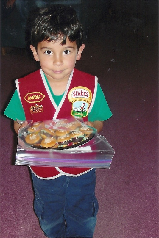 Child with minature hamburgers